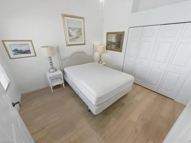 a bedroom with a bed and a white wall