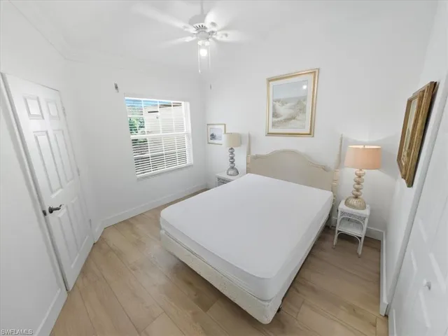 a bed room with a bed window and a chair