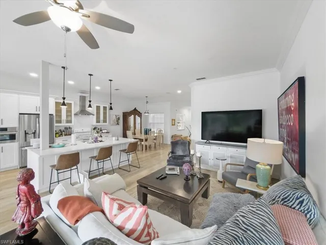 a living room with furniture a rug and a flat screen tv
