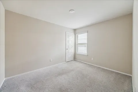 a view of an empty room and a window