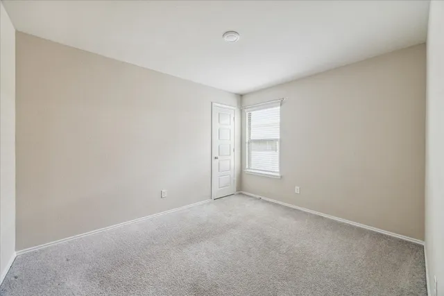 a view of an empty room and a window