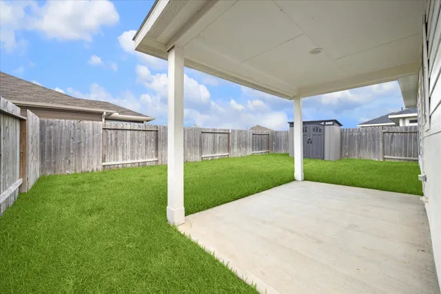 a view of a house with a big yard and large tree