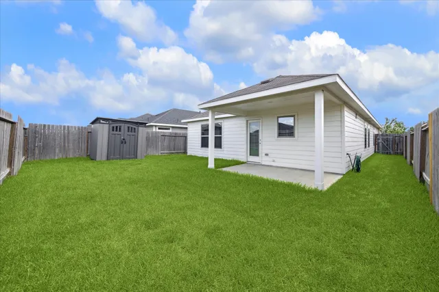 a view of a house with a backyard