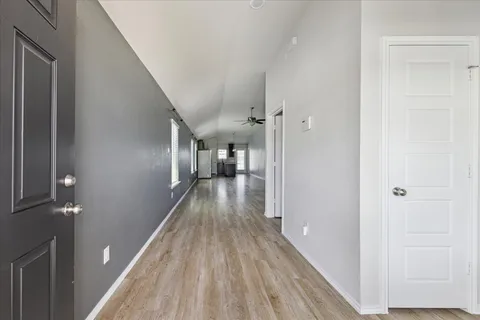 a view of hallway with wooden floor