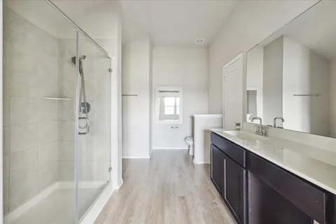 a bathroom with a double vanity sink a mirror and a bathtub