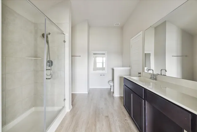 a bathroom with a double vanity sink a mirror and a bathtub