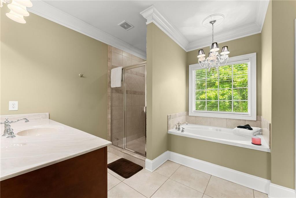 6643 Windvane Point Clermont, GA 30527 - Photo 30 of 88 a bathroom with a tub sink and shower