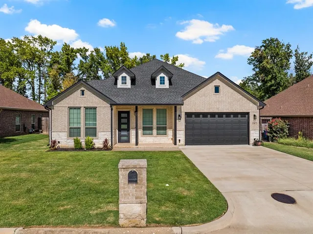 a front view of a house with a yard and porch