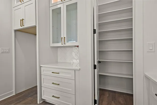 a view of walk in closet with empty racks