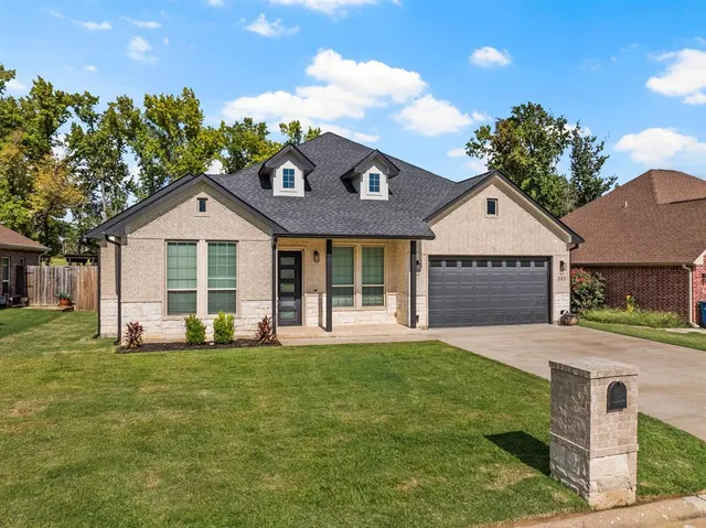 a front view of a house with a yard and porch