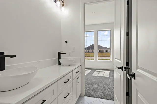 a bathroom with a tub sink and mirror