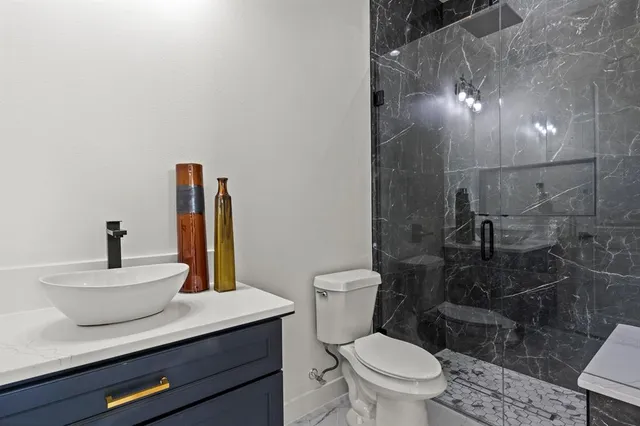 a bathroom with a sink a toilet and a mirror