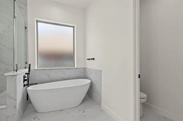 a white bath tub sitting in a bathroom
