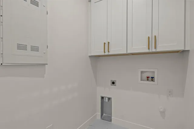 a view of kitchen with white cabinets