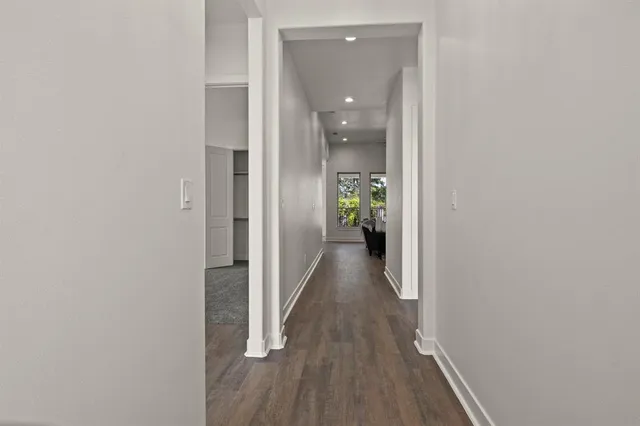 a view of a hallway with wooden floor