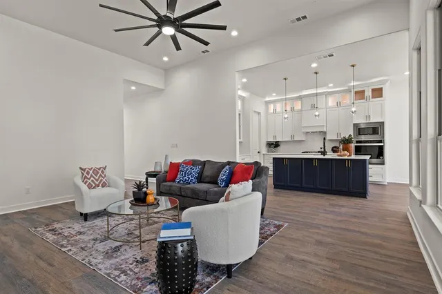 a living room with furniture and kitchen view