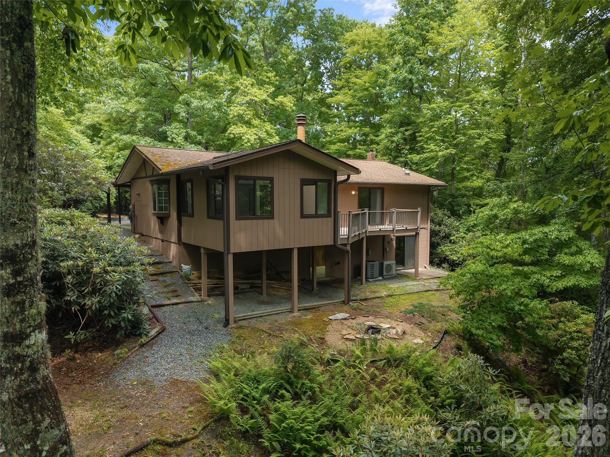 32 Honey Suckle Ridge Road Pisgah Forest, NC 28768 - Photo 2 of 35 a house with trees in the background