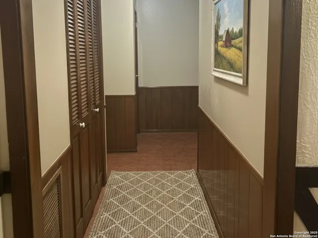 a view of hallway with wooden floor