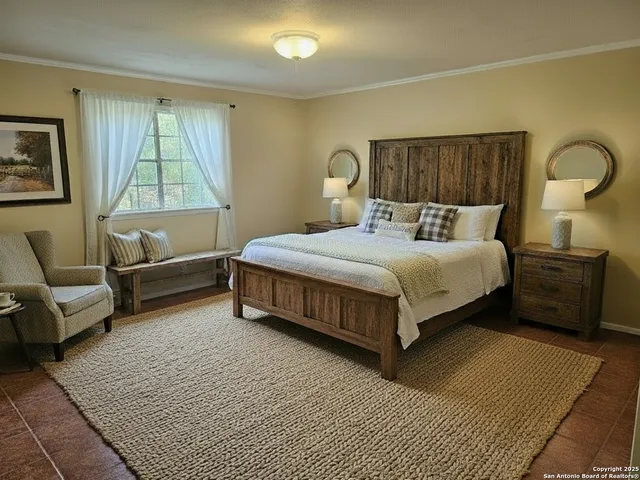 a bedroom with a bed couch and window