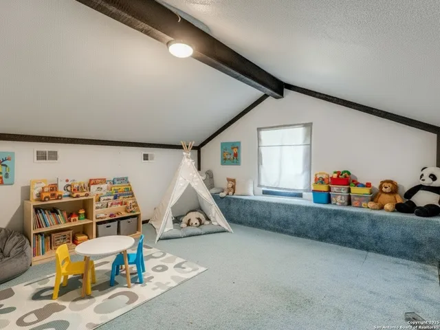 a room with furniture and white walls