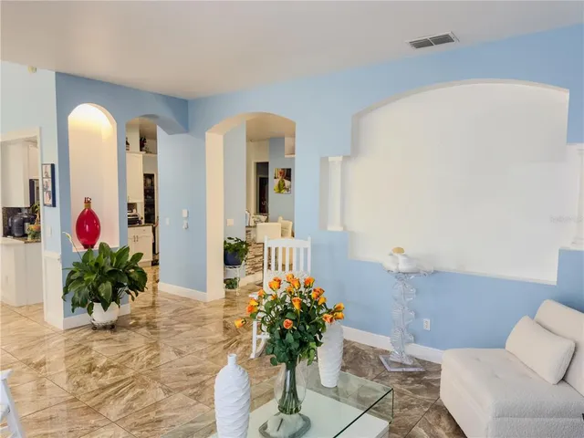 a living room with furniture flowerpot and a potted plant