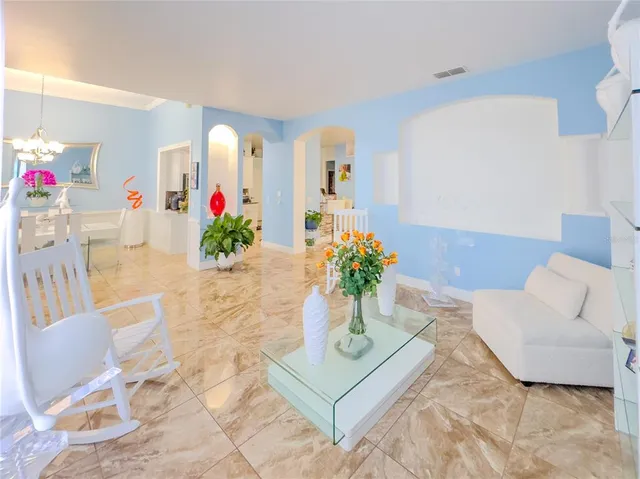 a living room with furniture and flowers