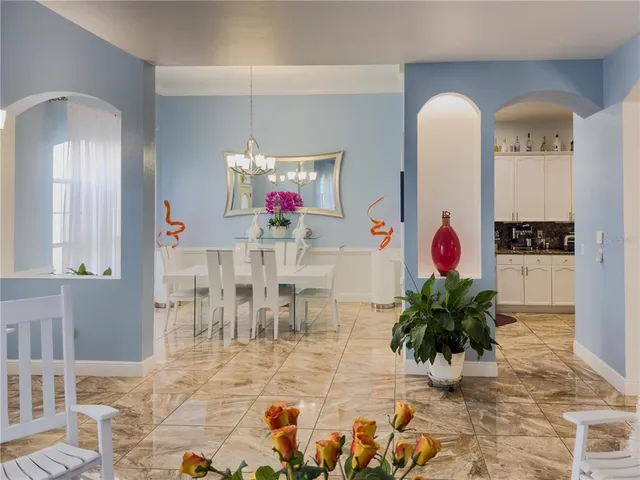 a view of dining room with furniture and flower vase