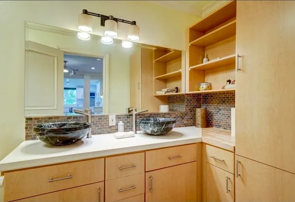 a kitchen with a sink and wooden floor