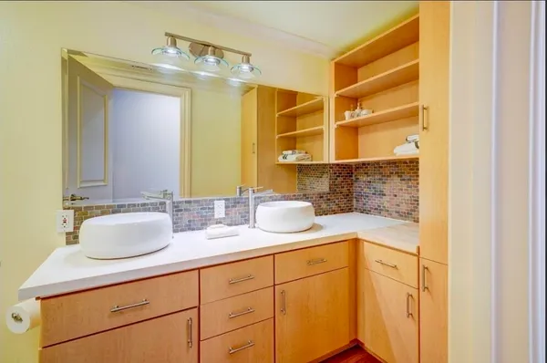 a bathroom with a sink a mirror and a shower