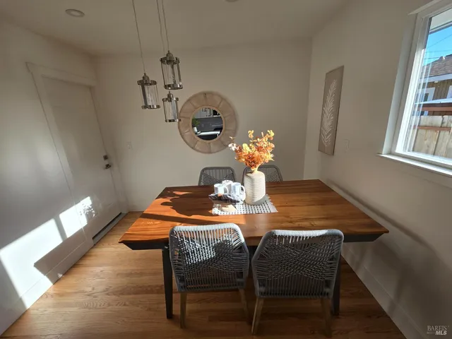 a dining room table with chairs and wooden floor