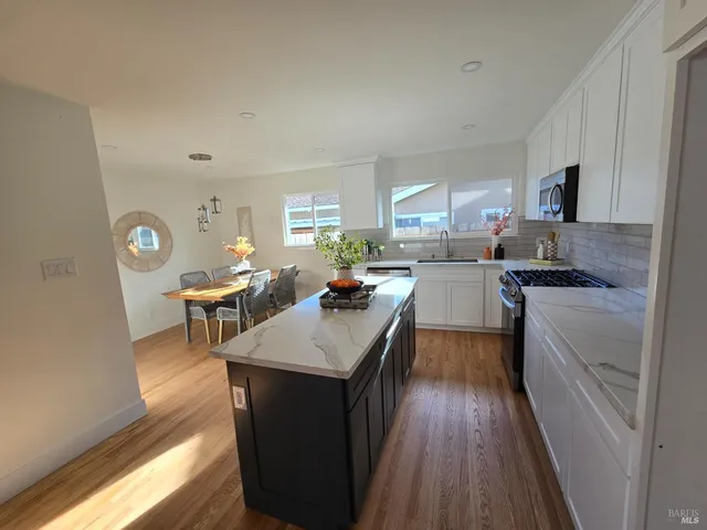 a kitchen with granite countertop lots of counter top space and appliances