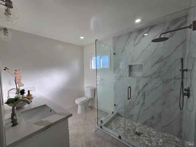 a bathroom with a sink toilet and shower