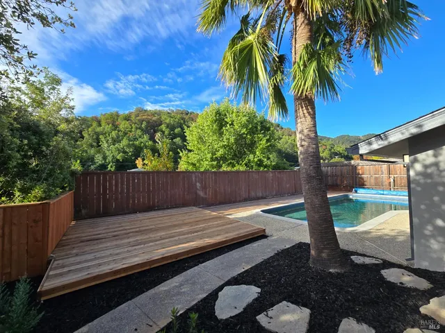a view of a wooden deck next to a yard