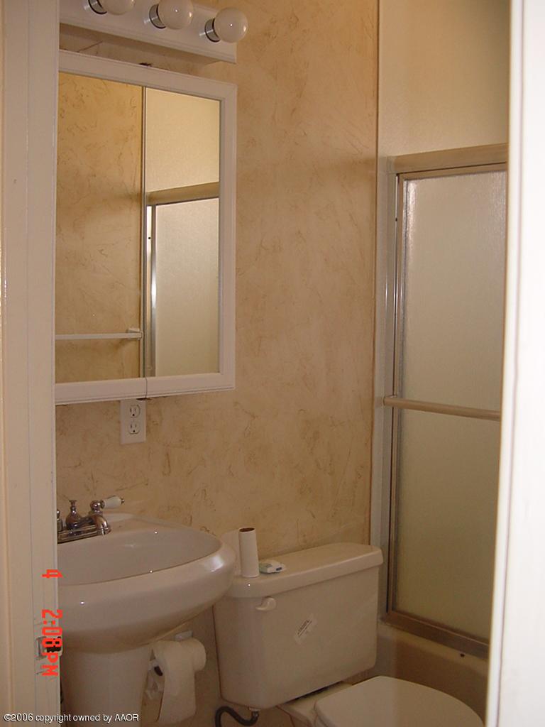 4113 Gables Street Amarillo, TX 79110 - Photo 7 of 8 a bathroom with a toilet and a shower