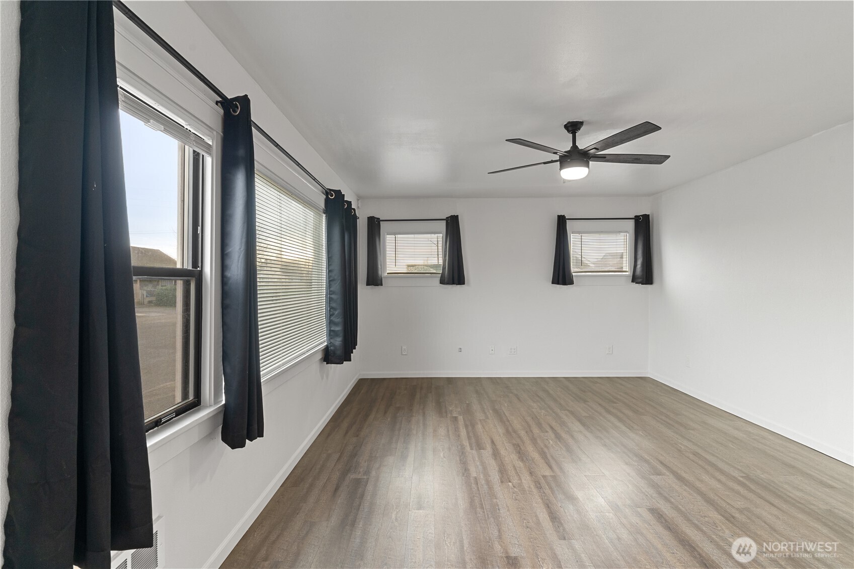 508 30th Street Hoquiam, WA 98550 - Photo 4 of 40 wooden floor in an empty room with a window