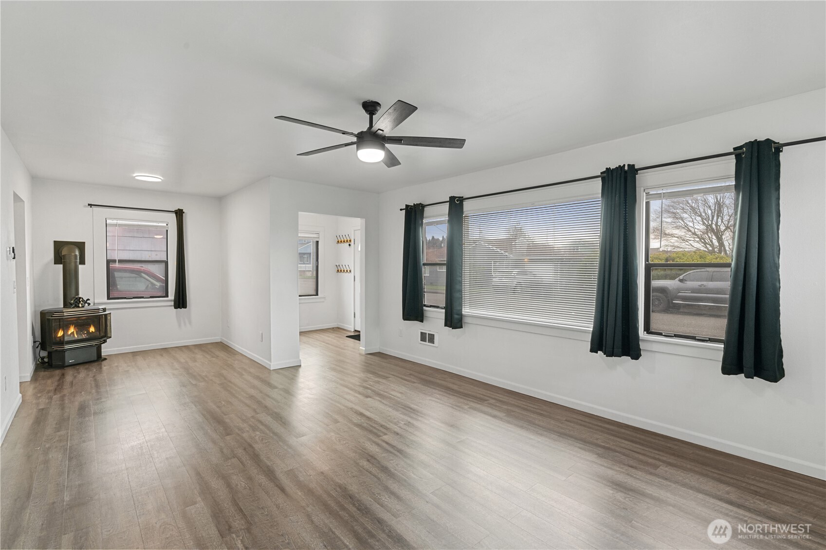 508 30th Street Hoquiam, WA 98550 - Photo 5 of 40 a view of an empty room with a window and wooden floor