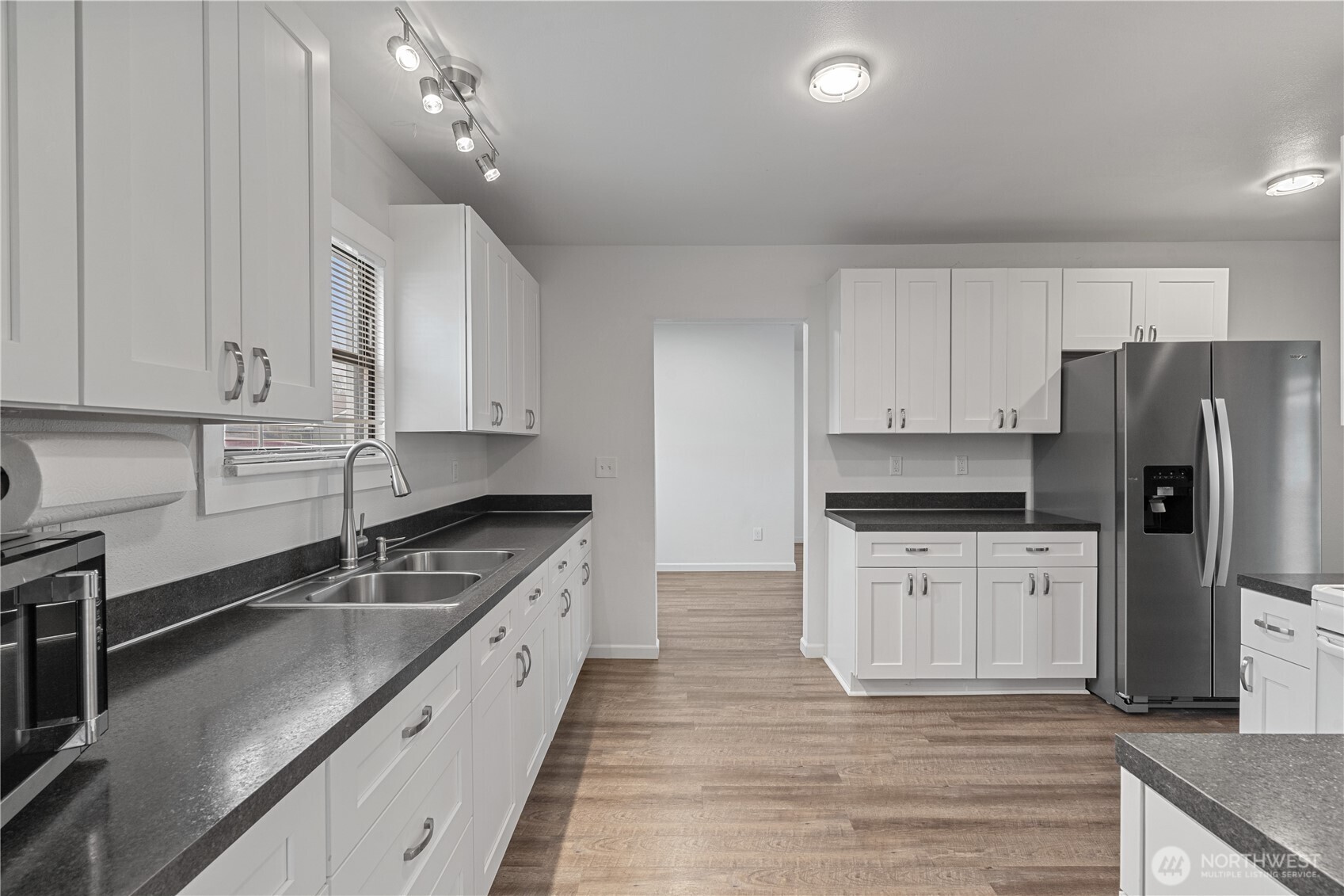 508 30th Street Hoquiam, WA 98550 - Photo 10 of 40 a kitchen with stainless steel appliances granite countertop a stove a sink and a refrigerator