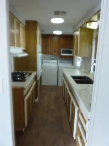 a kitchen that has a sink and a stove in it