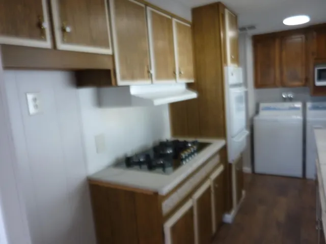 a kitchen with stainless steel appliances a stove a refrigerator and cabinets
