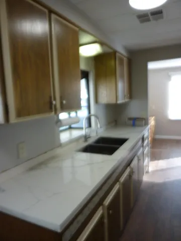 a kitchen with stainless steel appliances granite countertop a sink and a stove