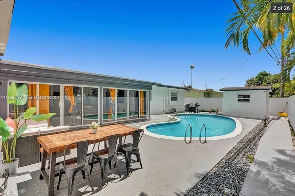 a view of a swimming pool with a table and chairs