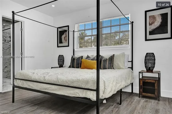 a bedroom with a bed a couch and dresser