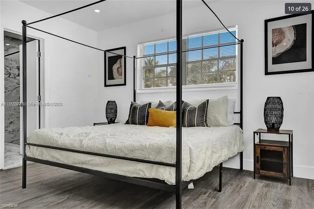 a bedroom with a bed a couch and dresser