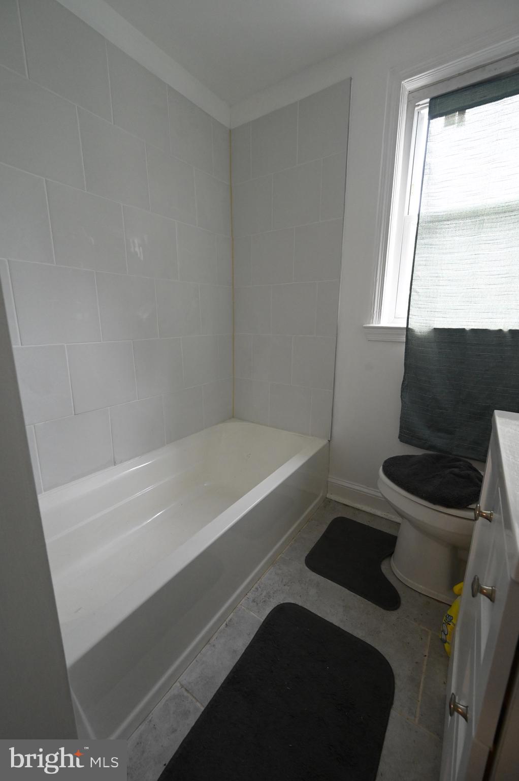 2458 Nevada Street Baltimore, MD 21230 - Photo 12 of 19 a bathroom with a bathtub and a window