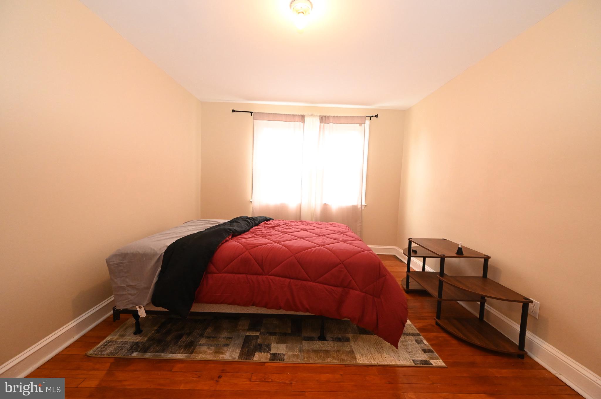 2458 Nevada Street Baltimore, MD 21230 - Photo 14 of 19 a room with a bed a mirror and a window