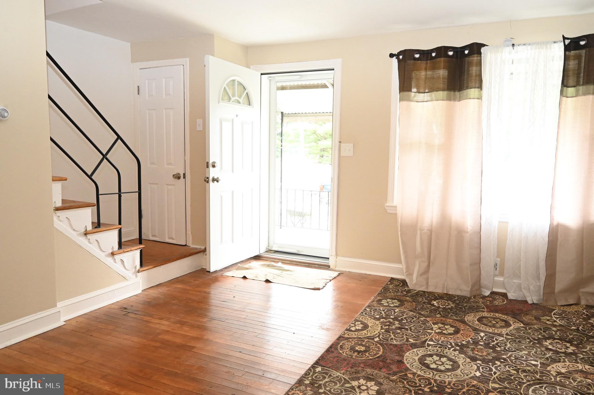 2458 Nevada Street Baltimore, MD 21230 - Photo 2 of 19 a view of an empty room with wooden floor and a window