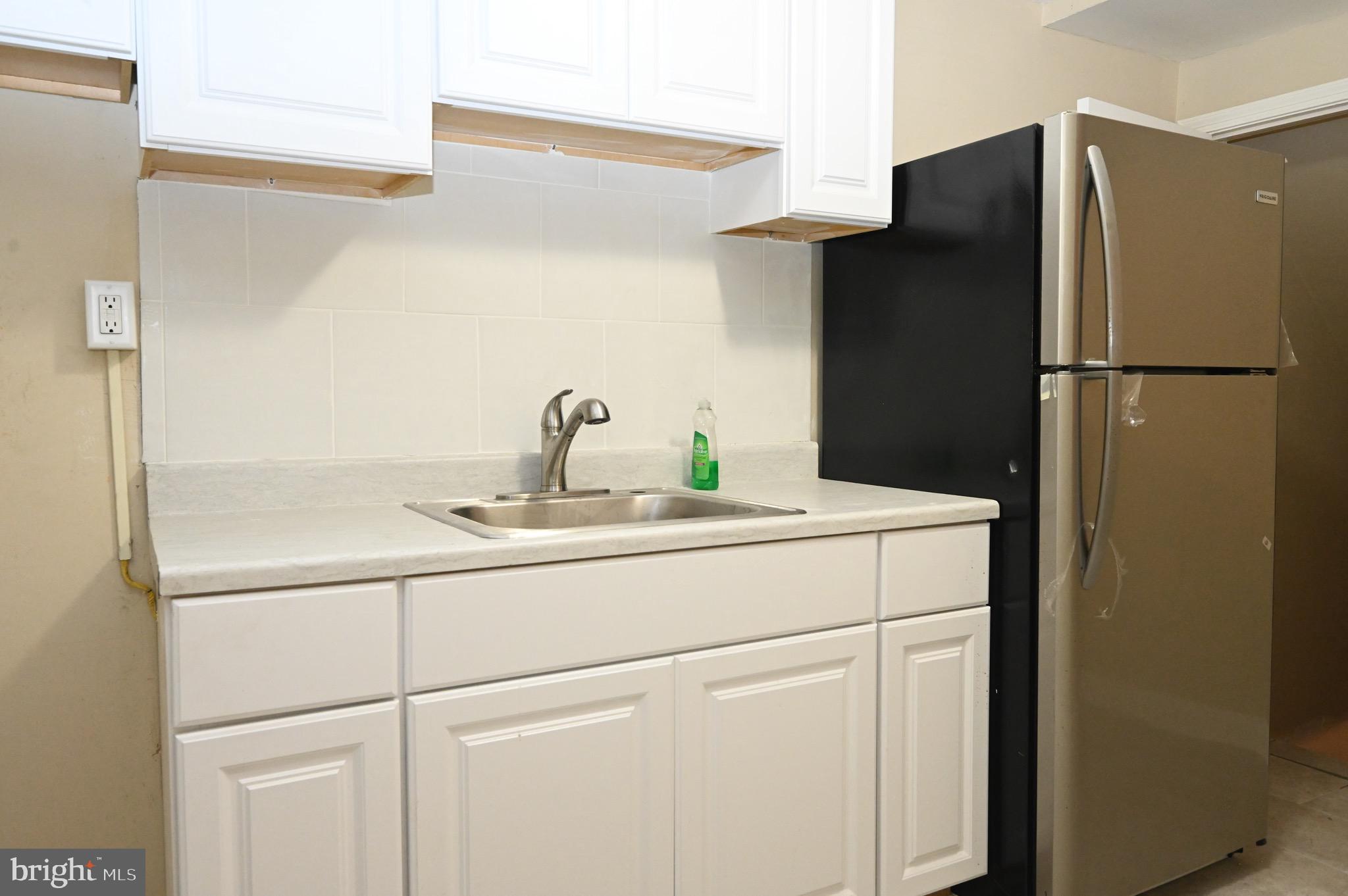 2458 Nevada Street Baltimore, MD 21230 - Photo 5 of 19 a kitchen with a refrigerator and cabinets