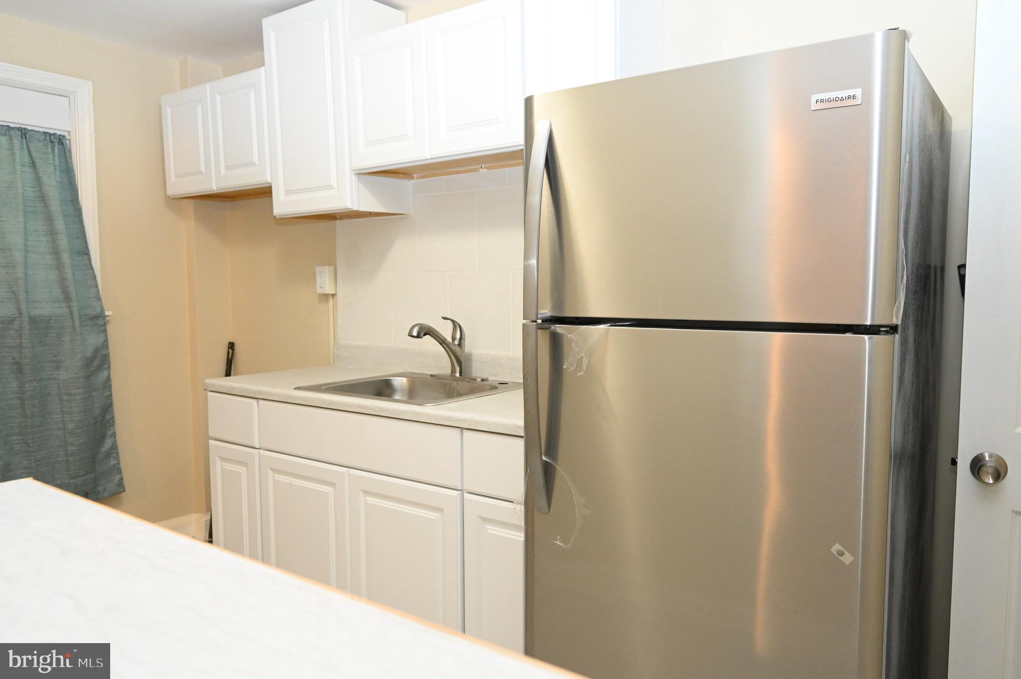 2458 Nevada Street Baltimore, MD 21230 - Photo 7 of 19 a white refrigerator freezer sitting inside of a kitchen