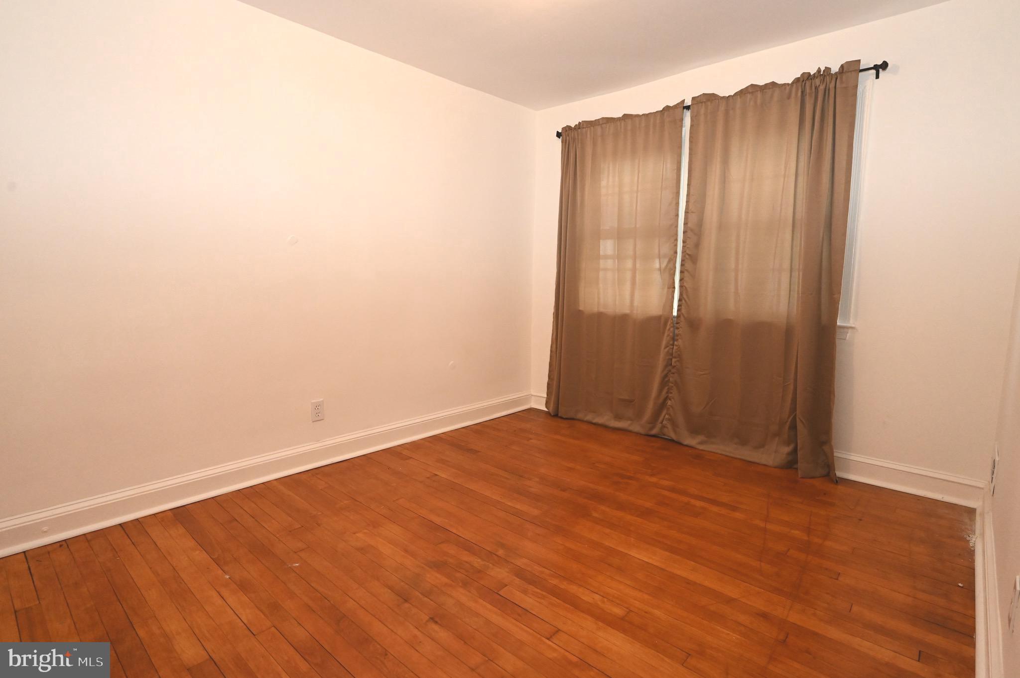 2458 Nevada Street Baltimore, MD 21230 - Photo 8 of 19 an empty room with wooden floor