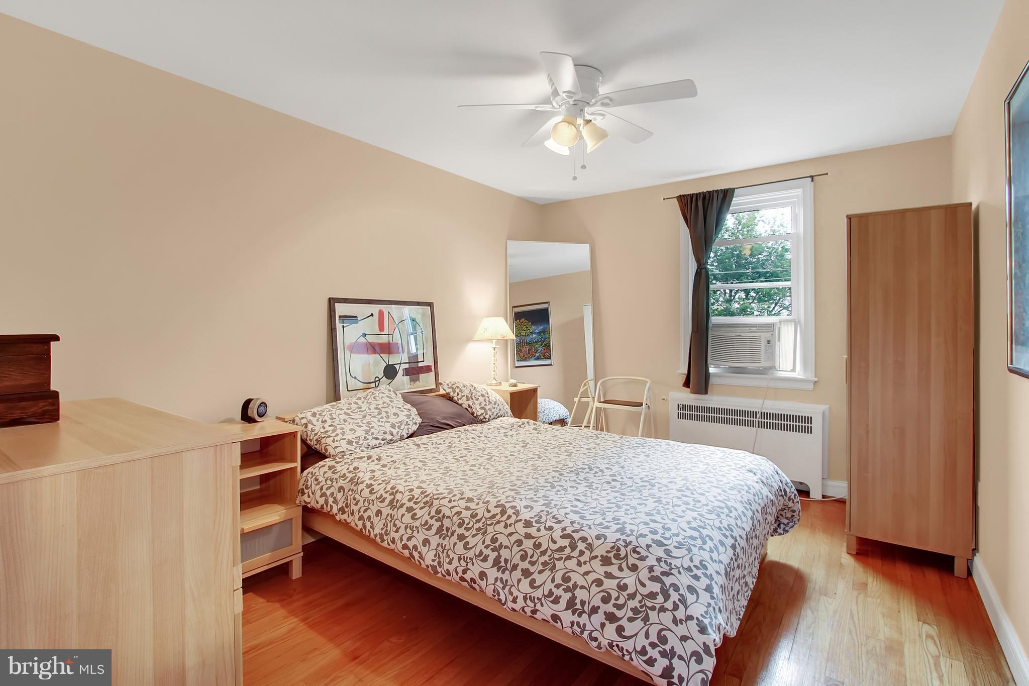 3605 Ednor Road Baltimore, MD 21218 - Photo 11 of 23 a bedroom with a bed chandelier and a window